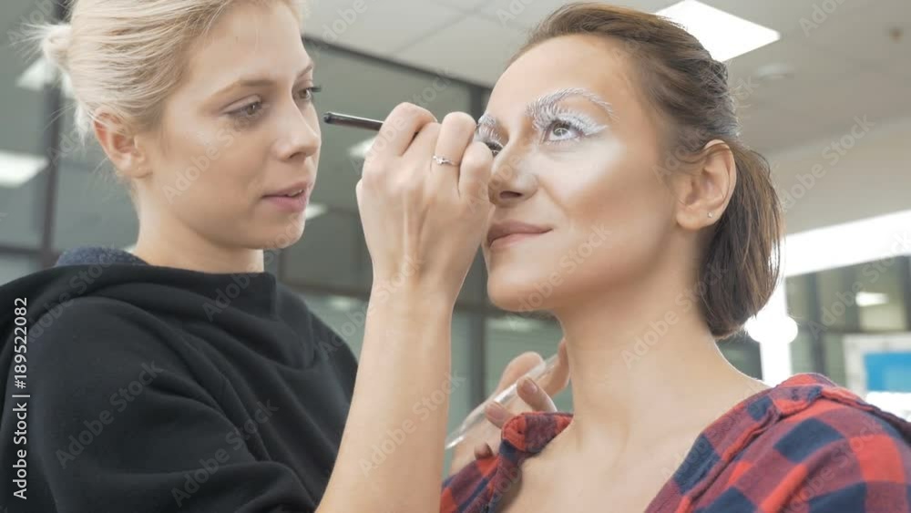 A professional make-up artist does the make-up of the model. A professional make-up artist does the make-up of the model.