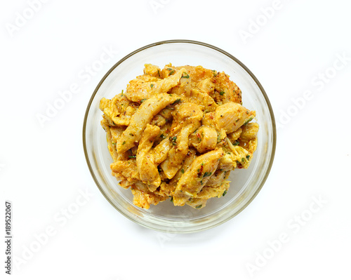 Indian chicken curry ready to cook. Marinated Chicken in chili, turmeric and different spices, isolated on white background.