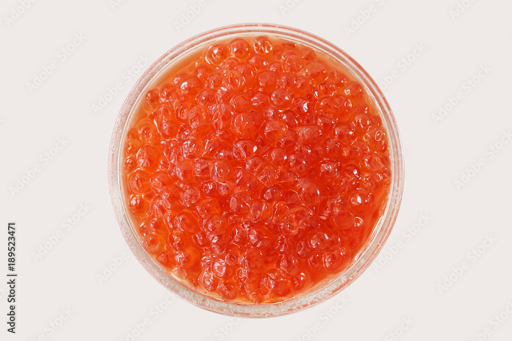 Glass bowl with red salmon caviar on white background. View from above. Popular souvenir from Russia. Glass bowl with red salmon caviar on white background. View from above. Popular souvenir from Russia.