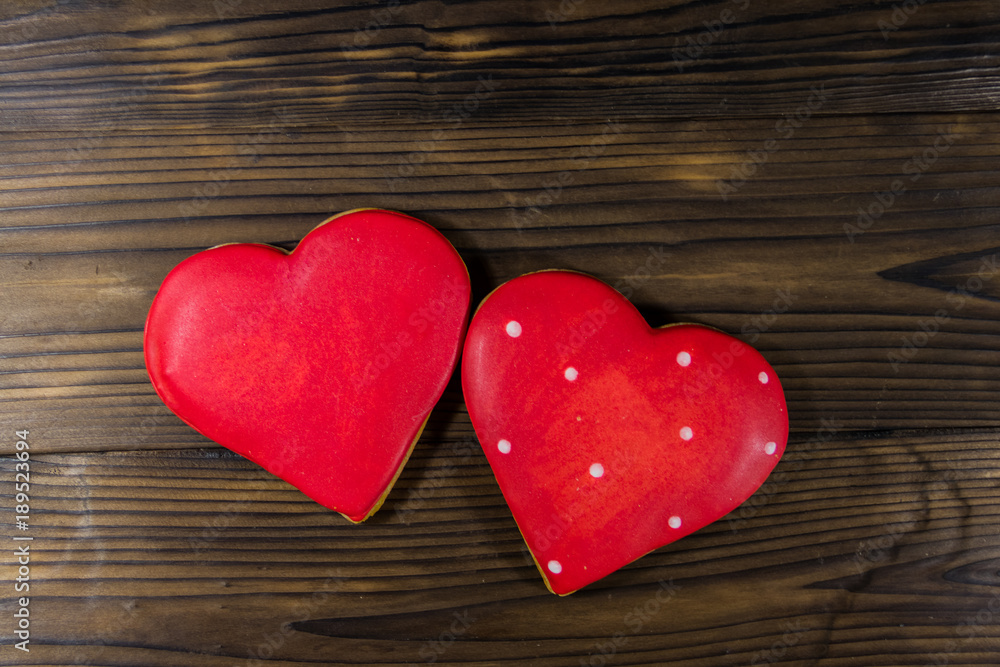 Heart shaped cookies for valentine day on wooden table. Top view Heart shaped cookies for valentine day on wooden table. Top view