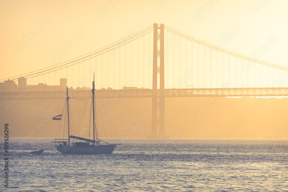 Bridge 25th of April in Lisbon, Portugal at sunset