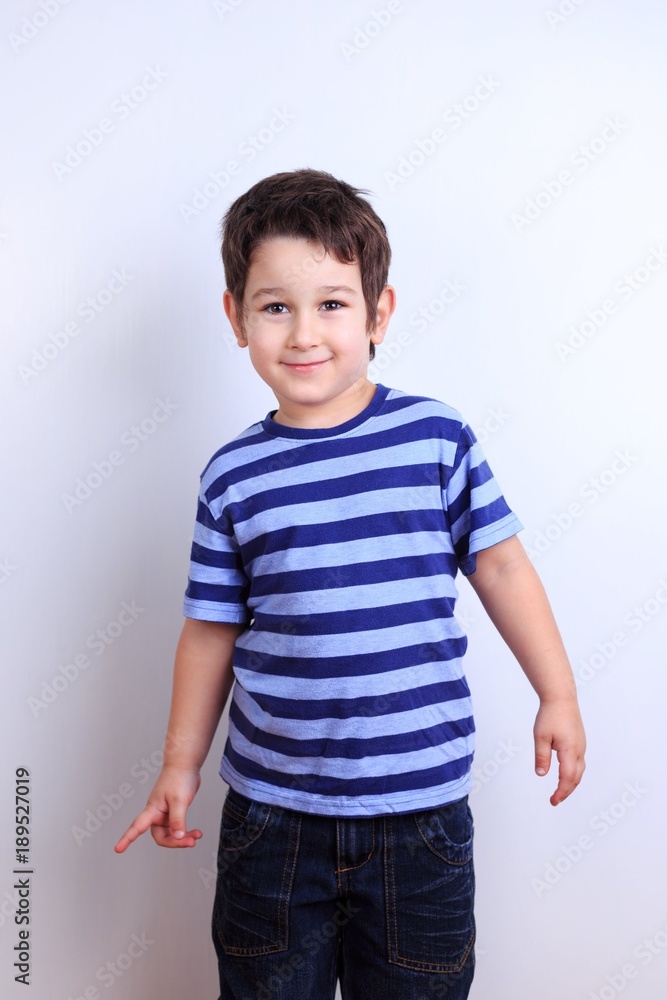 Cute happy boy smiling, close up studio shoot on white. Emotions, feelings, states of mind, childhood concept Cute happy boy smiling, close up studio shoot on white. Emotions, feelings, states of mind, childhood concept