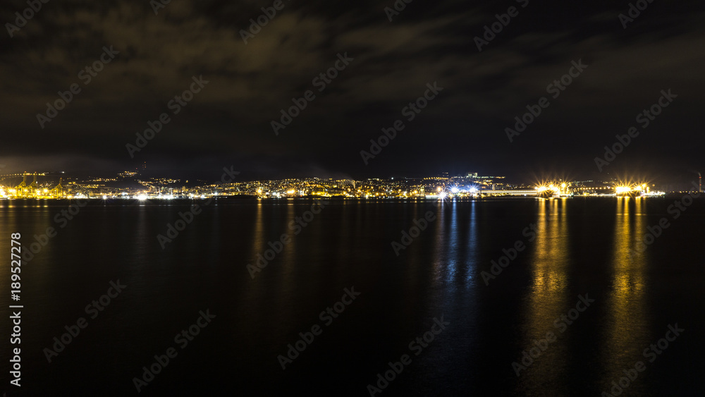 Triest in Italy at night skyline view of harbor sea. Shot taken  from Muggia