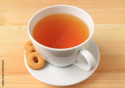 Cup of Hot Tea with Cookies on the Wooden Table