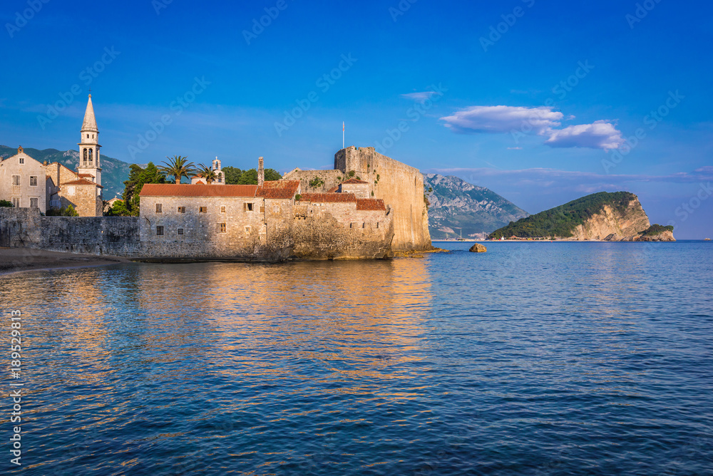 Old Town citadel in Budva town over Adriatic Sea, Montenegro. Island of Saint Nicholas on background