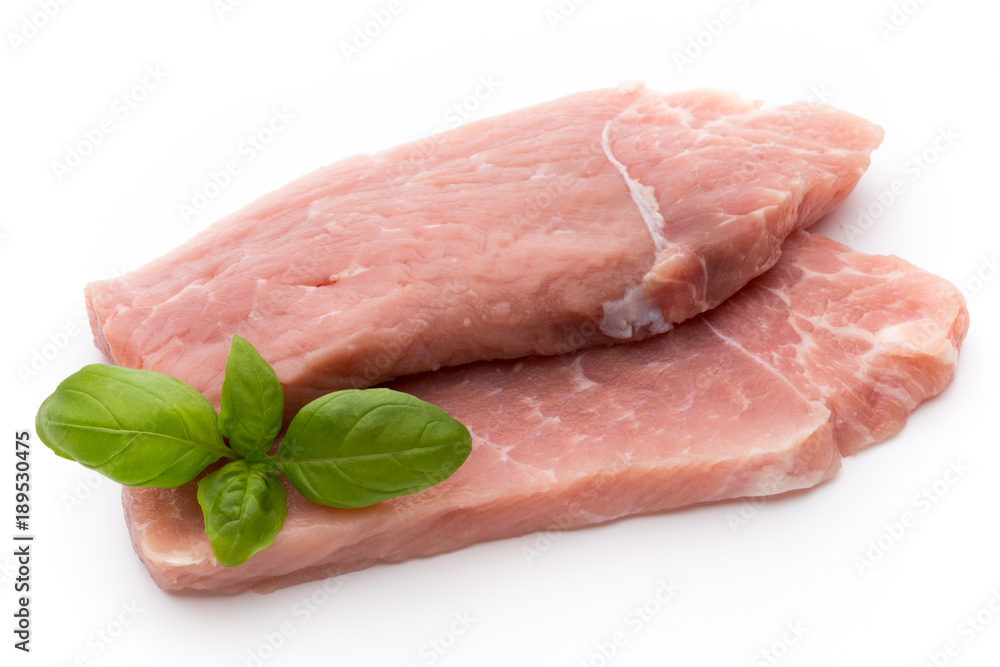 Fresh pork fillet with basil on a white background. Fresh pork fillet with basil on a white background.