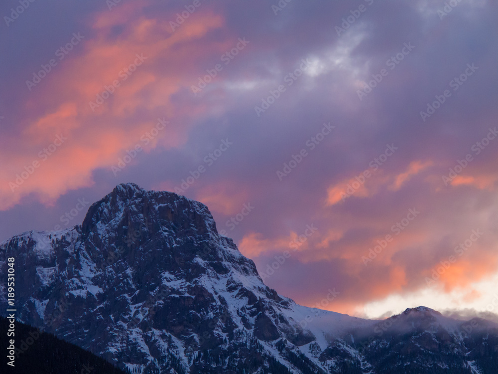 Mountain peak orange pink sunset clouds 