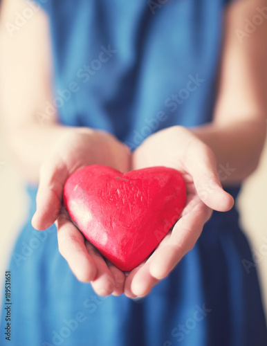 Heart in girl's hands, close up