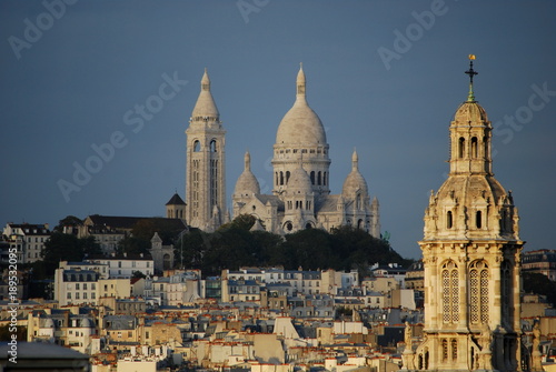 An amazing view of the Sacre Coeur with the Church of Saint Trinity in the foreground
