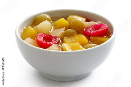 Photography White ceramic bowl of fruit cocktail isolated on white.
