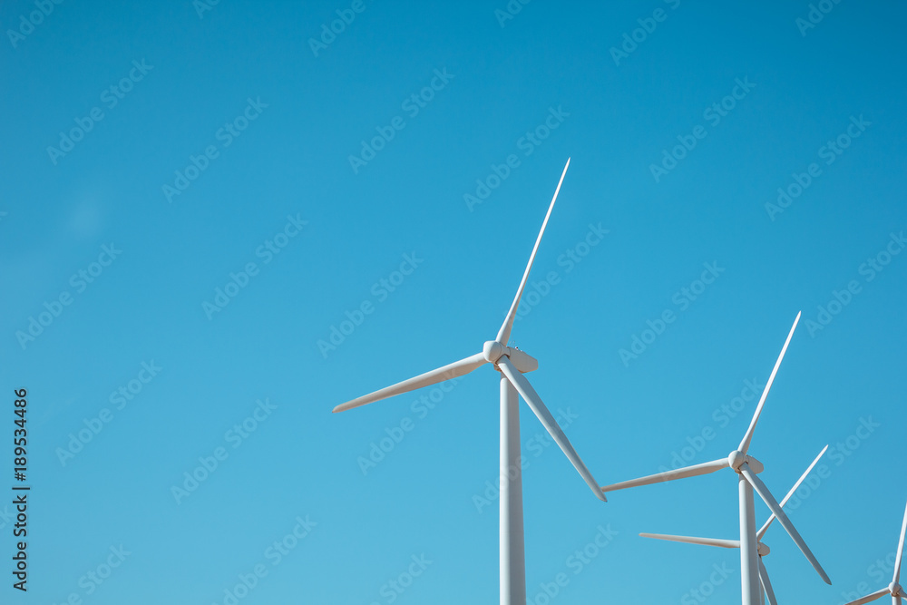 Wind generator against the blue sky