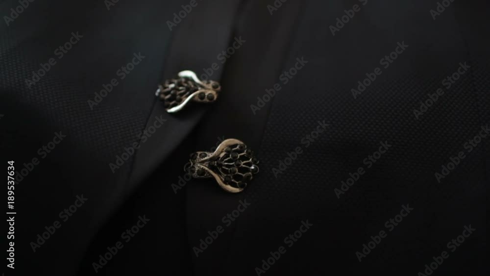 Metal buttons on the tuxedo of the groom Metal buttons on the tuxedo of the groom