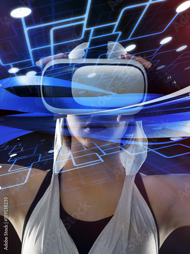 A girl in a suit with silver hoods and glasses of virtual reality on a beautiful abstract background.