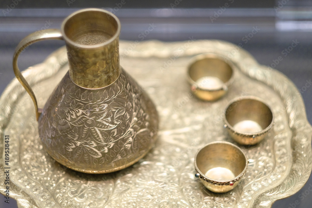 An old set of metal dishes made in the technique of stamping An old set of metal dishes made in the technique of stamping