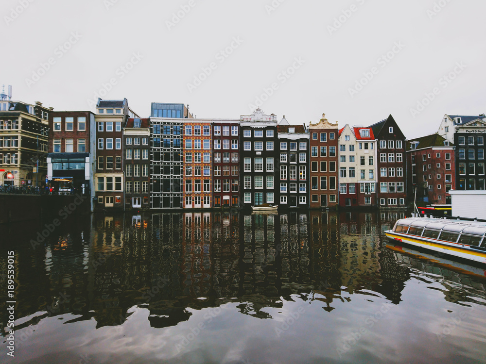 The city of Amsterdam, colorful houses that stand above the water