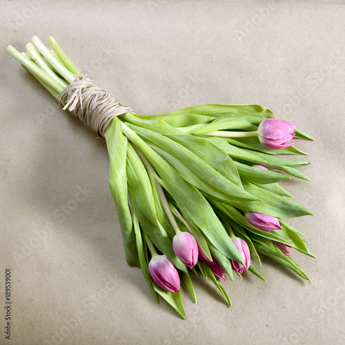 the Wedding bouquet of pink tulips on a kraft paper background as a greeting card for Valentine s day