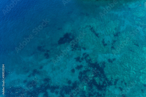 Aerial view on turquoise waves, water surface texture. 