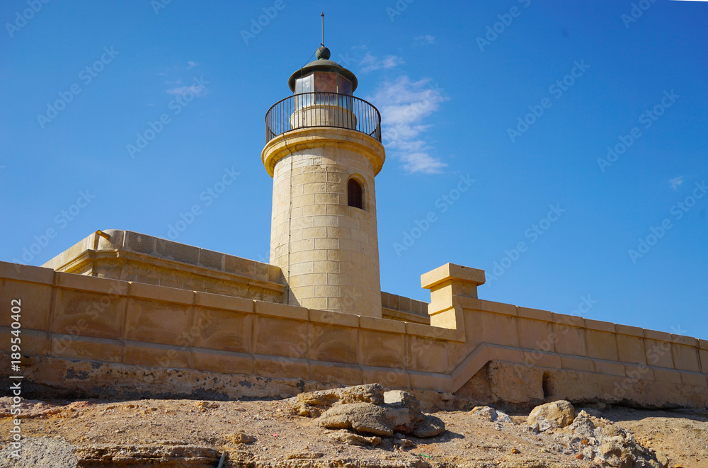 Old stone lighthouse on a rocky shore