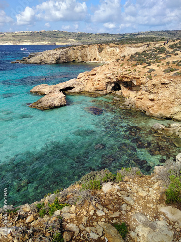 Comino island blue lagoon. Malta blue turquoise sea water beach. Rock and cliff sunny seashore. Travel mediterranean.