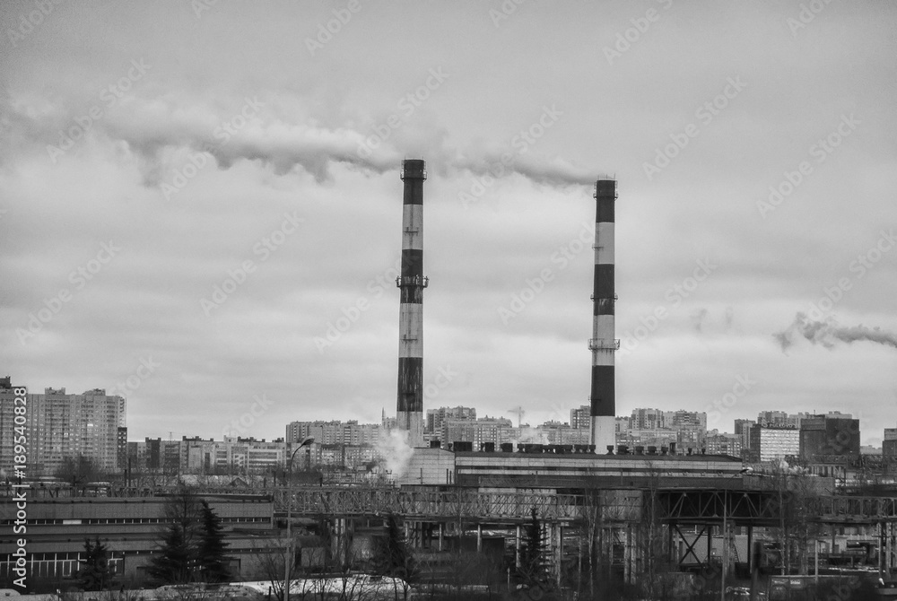 Obraz premium Factory in the city. Environmental pollution threat. Black and white.