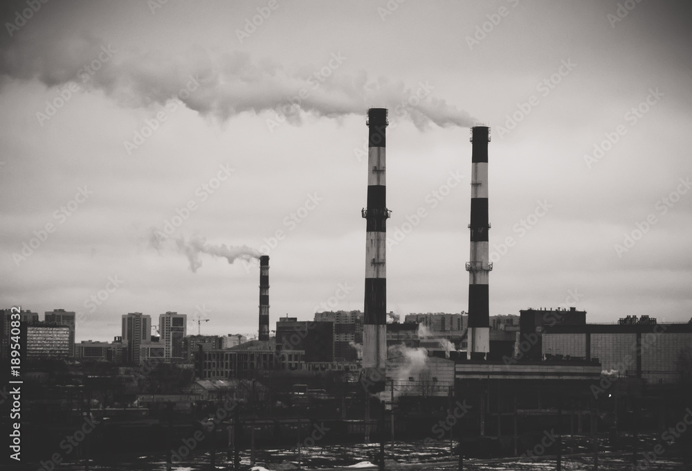 Factory in the city. Environmental pollution threat. Black and white.