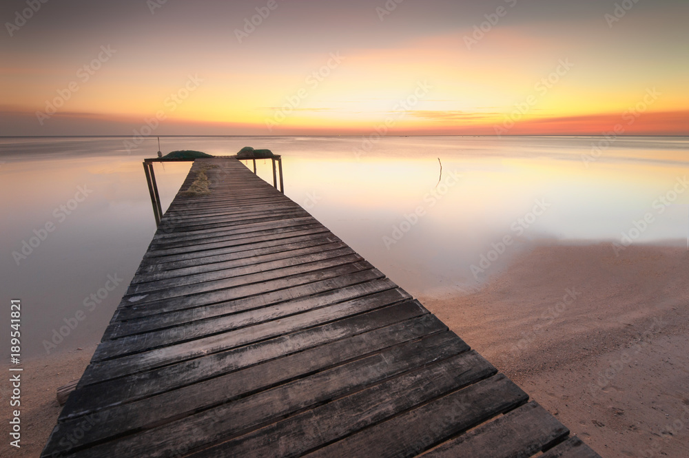 wooden jetty during sunset at Kudat Sabah Malaysia. soft focus and blur due to long expose.