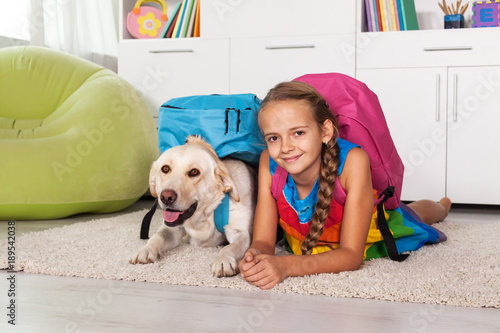 Young girl and her labrador dog ready for school