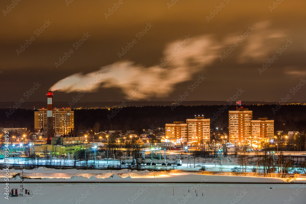 Night scenic view on Moscow district and smoke from the pipe above. Russia.