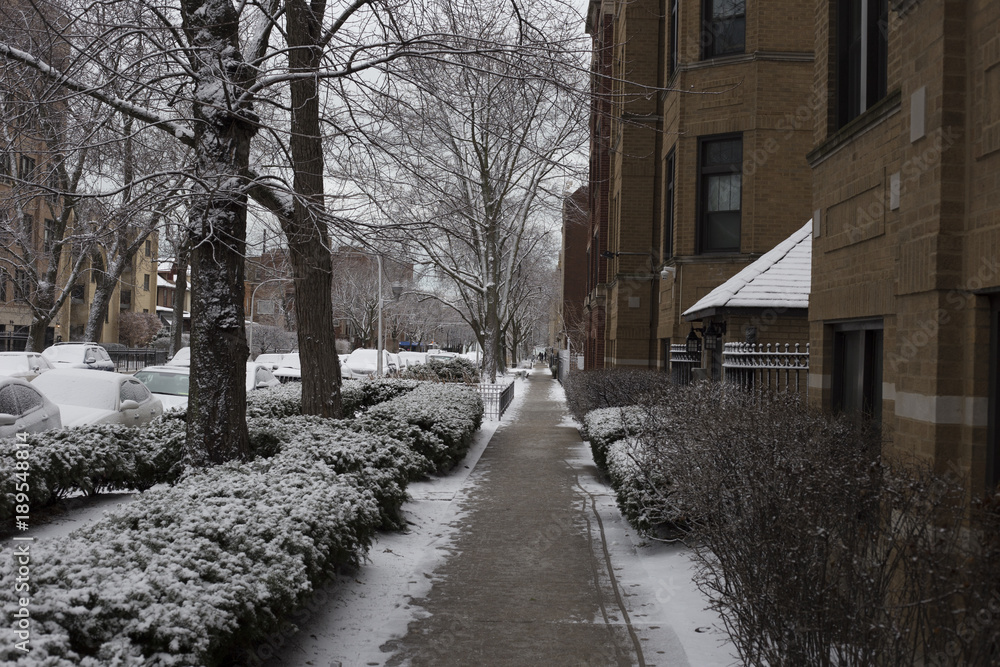 Looking down a snow covered sidewalk Looking down a snow covered sidewalk