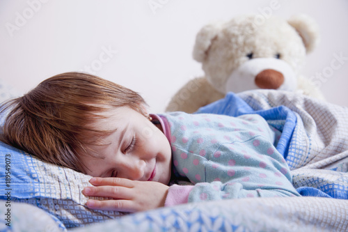 Child girl relaxing in bed. (Sleep, health, happiness, childhood concept)