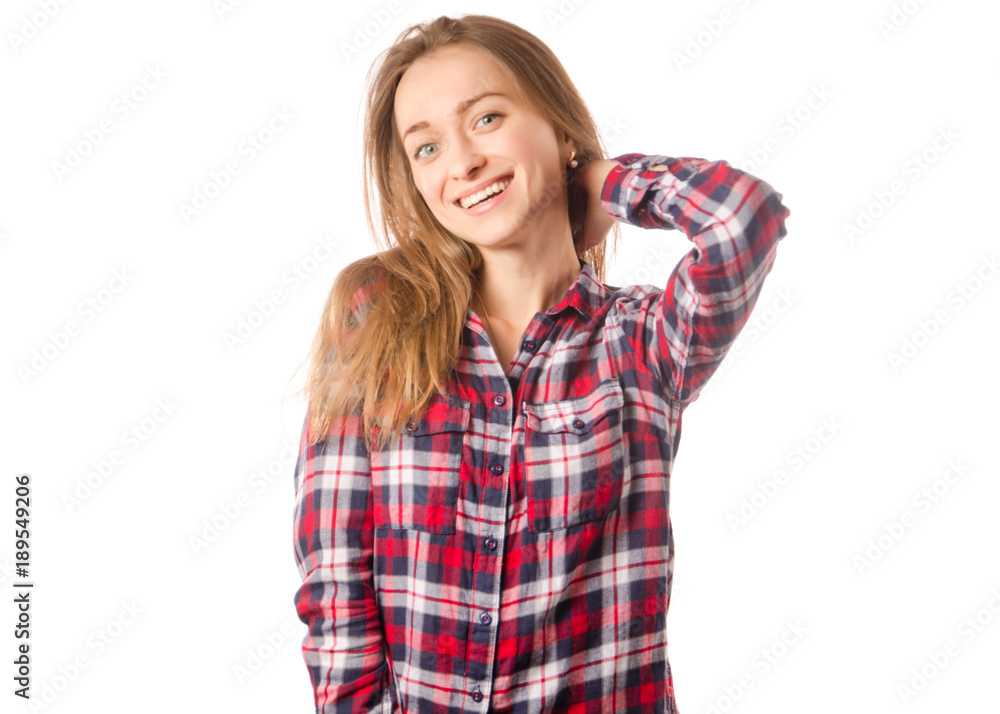 Woman in shirt smiles holding the back of the head Woman in shirt smiles holding the back of the head