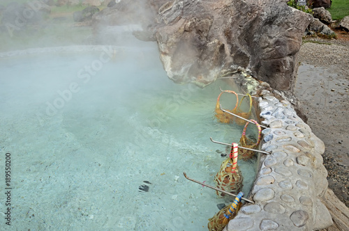 Hot springs eggs in bamboo basket boil in hot water at sankampaeng hot spring Chiang Mai, Thailand. photo