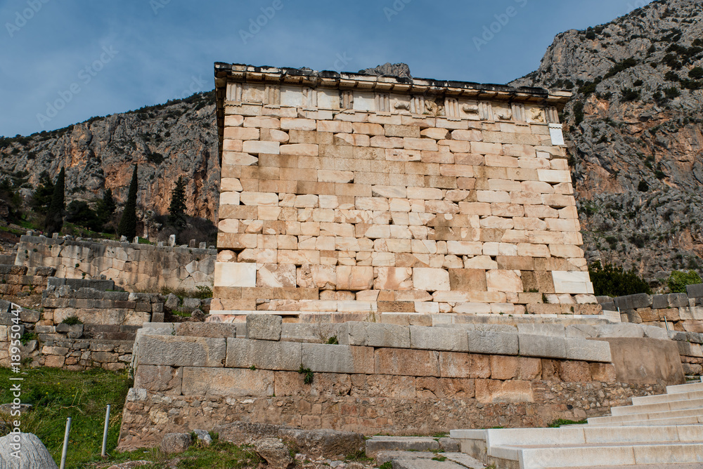 Athenian Treasury in Delphi, an archaeological site in Greece, at the Mount Parnassus. Delphi is famous by the oracle at the sanctuary dedicated to Apollo. UNESCO World heritage