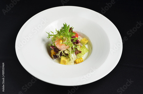Fresh avocado and shrimps salad on white plate 