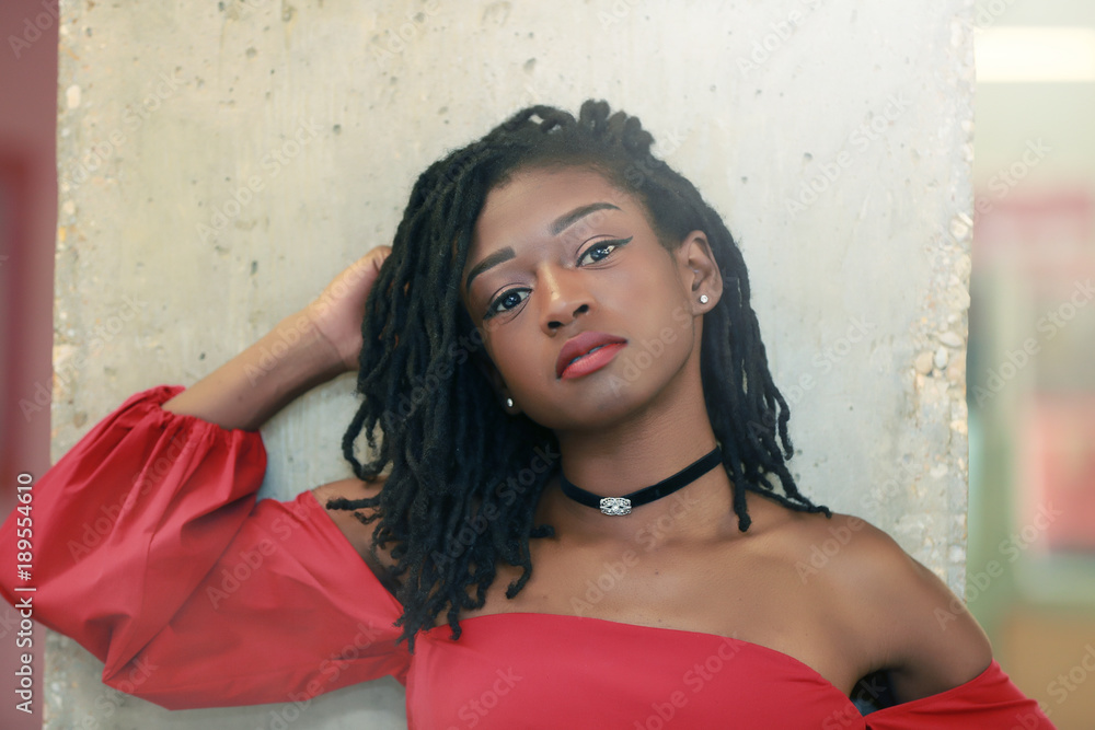 Black female posing near cement column Black female posing near cement column