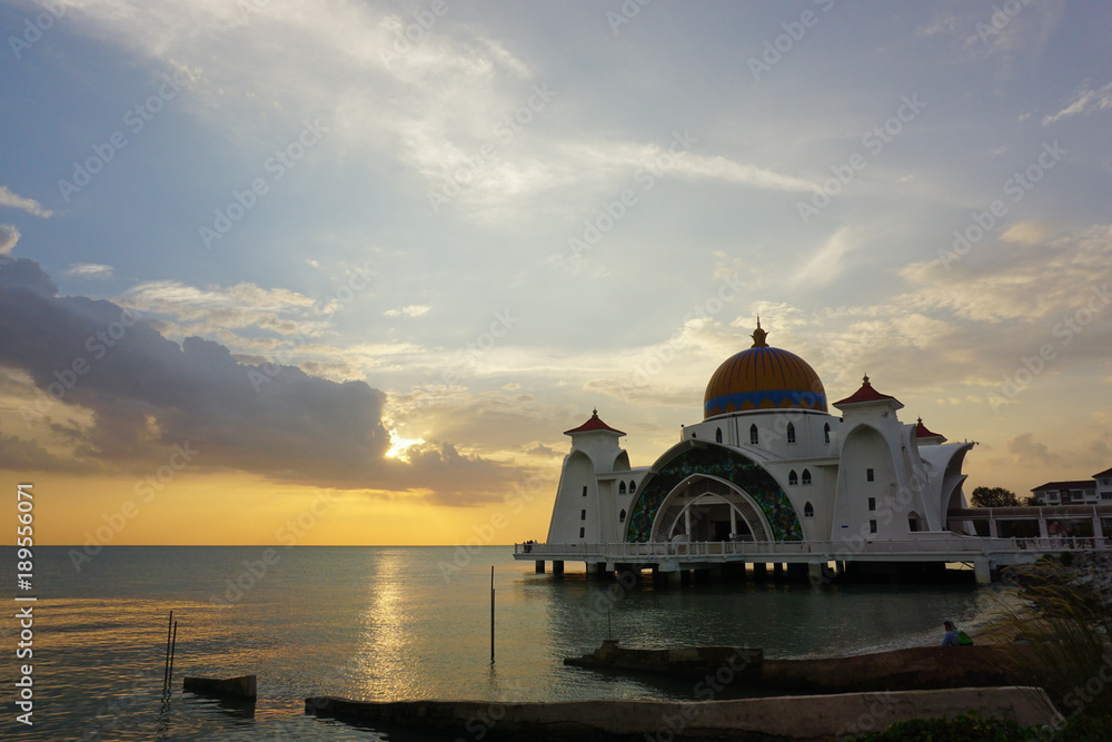 Beautiful sunset over the white floating mosque.