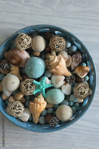 Shells, Colored Stones and Wicker Balls in Bowl Overhead