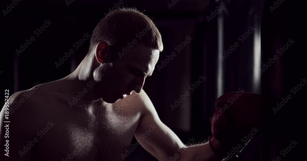 Kickboxer tired after strength training exercise at gym. Tired man after training. Eoung boxer tired after strength training exercise at gym. Exhausted fighter Kickboxer tired after strength training exercise at gym. Tired man after training. Eoung boxer tired after strength training exercise at gym. Exhausted fighter