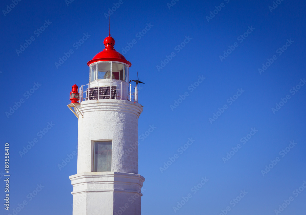 White lighthouse on a blue background.