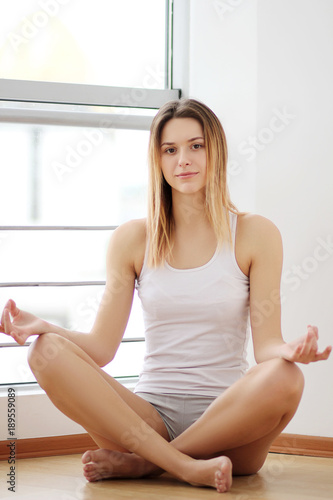 Free Download Young woman in luxury modern apartment, wearing shirt gown drinking coffee and looking at cityscape, enjoying new floor to ceiling windows, dreaming of success in the big city. Rear view - GFXLoad