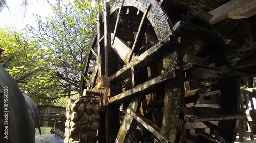 Wooden water mill wheel spinning