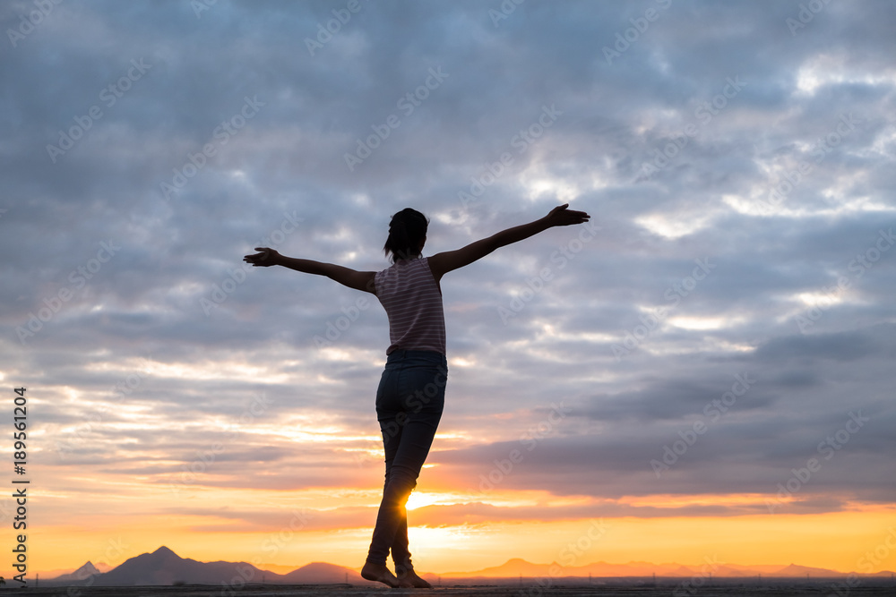 Young woman relaxing in summer sunset sky outdoor. People freedom style.