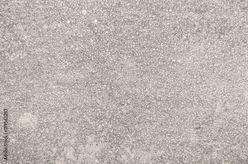 speckled cement covered with fine spray of pale gray paint