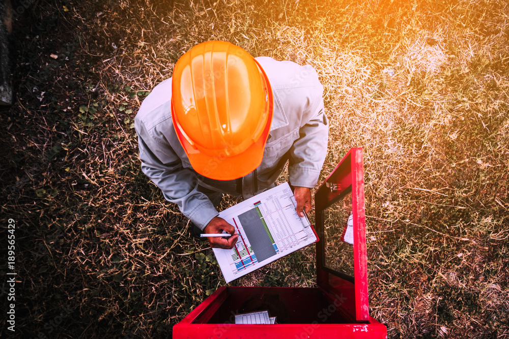 custom made wallpaper toronto digitalsafety officer working on checking Fire extinguisher at outdoor plant.