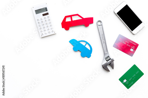 Car repair concept. Cost calculation. Car silhouette, calculator, bank card, wrench on white backgound top view copy space