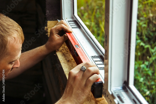 worker checks the level of a window