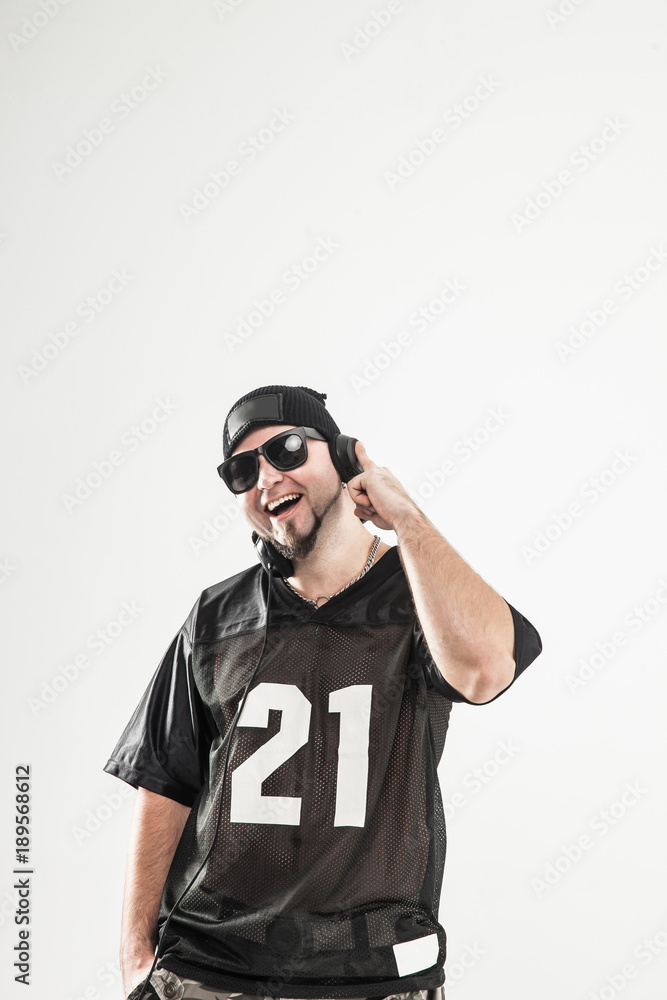 emotional and charismatic DJ - rapper with headphones on a light emotional and charismatic DJ - rapper with headphones on a light