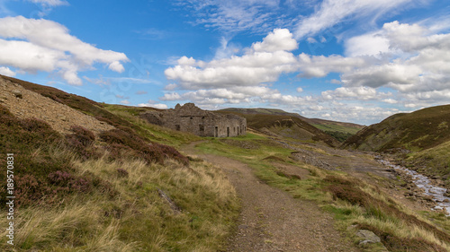 Yorkshire Dales landscape with the ruins of the Surrender Smelt Mill, between Feetham and Langthwaite, North Yorkshire, UK