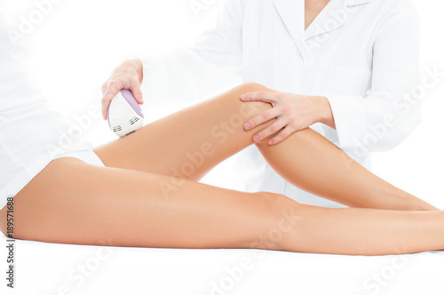 Beautician removing hair of woman's leg. Laser depilation