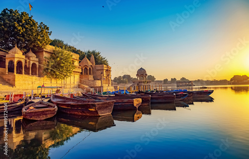 Gadisar lake (Gadi Sagar) Jaisalmer Rajasthan with ancient architecture and tourist boats at sunrise